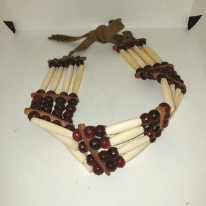 Tribal multi strand necklace appears to be made of bone, wood and suede